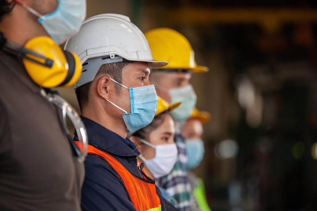 Oil & Gas field workers from different departments as inspection, construction, etc... wearing protective gears and masks, to avoid coronavirus transmission, stopped in the working area. It seems that they are waiting for something, probably for the end of this pandemic situation, because as Nexua excellence quallity explains in this article, coronavirus has had a big impact on the oil & gas sector delaying all projects.